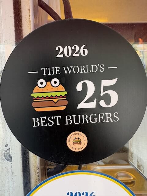 Round black Burgerdudes sticker reading "2026 The World's 25 Best Burgers"