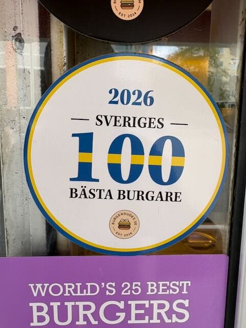 Round Burgerdudes sticker reading "2026 Sveriges 100 bästa burgare" (Sweden's 100 Best Burgers 2026)